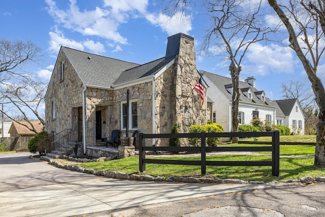 805 Allison Gdns, Columbia, TN 38401 - view of front of home featuring stone siding, roof with shingles, a chimney, and driveway