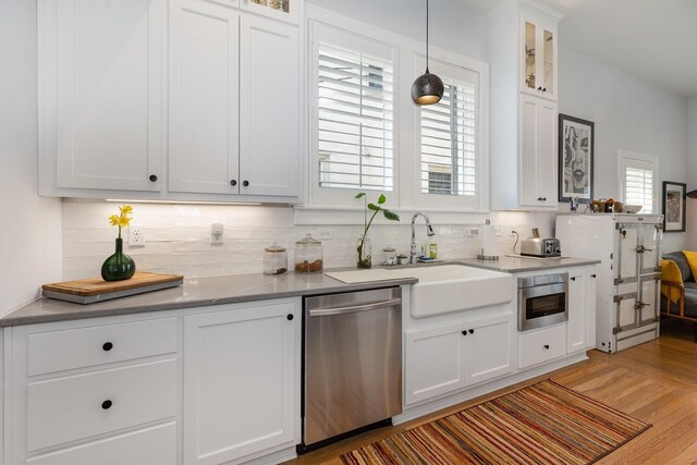805 Allison Gdns, Columbia, TN 38401 - kitchen with dishwasher, backsplash, white cabinetry, and glass insert cabinets