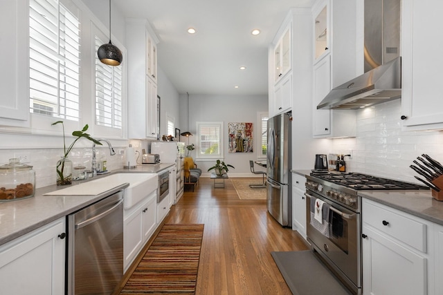 805 Allison Gdns, Columbia, TN 38401 - kitchen with stainless steel appliances, white cabinetry, wall chimney exhaust hood, backsplash, and recessed lighting
