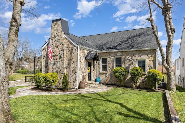 805 Allison Gdns, Columbia, TN 38401 - view of front of house featuring stone siding, a front lawn, a chimney, and roof with shingles