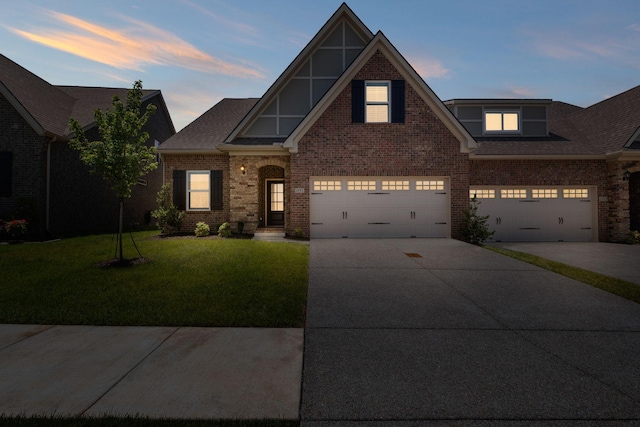 1551 Cedarbrooke Ln, Lebanon, TN 37090 - view of front facade with brick siding, a front lawn, concrete driveway, a garage, and a shingled roof