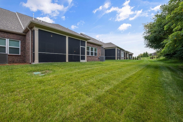 1551 Cedarbrooke Ln, Lebanon, TN 37090 - back of house with a sunroom, brick siding, a lawn, and roof with shingles