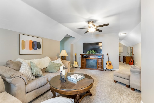 423 Adeline Dr, Smyrna, TN 37167 - carpeted living room featuring ceiling fan, vaulted ceiling, and a glass covered fireplace