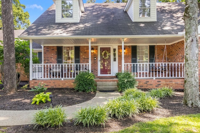 423 Adeline Dr, Smyrna, TN 37167 - new england style home with a porch, brick siding, and roof with shingles