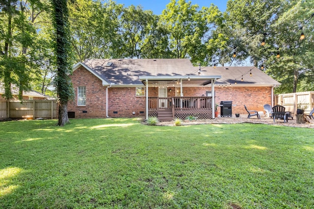 423 Adeline Dr, Smyrna, TN 37167 - rear view of property featuring a fenced backyard, crawl space, brick siding, and an outdoor fire pit