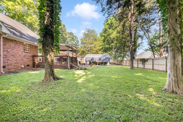 423 Adeline Dr, Smyrna, TN 37167 - fenced backyard with a wooden deck and an outbuilding