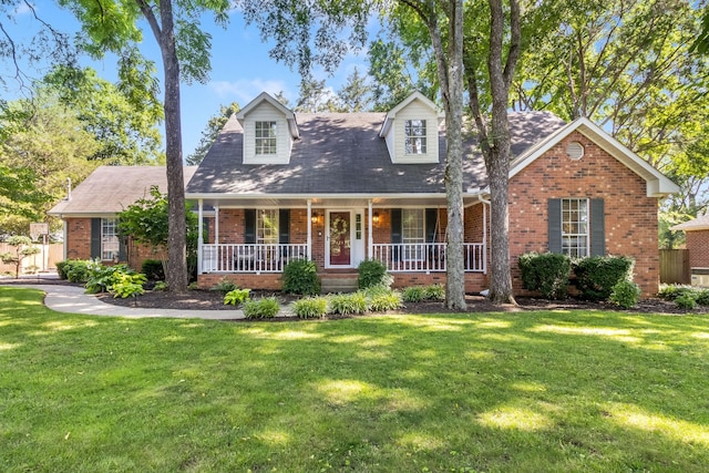 423 Adeline Dr, Smyrna, TN 37167 - cape cod home featuring brick siding, a front yard, covered porch, and a shingled roof