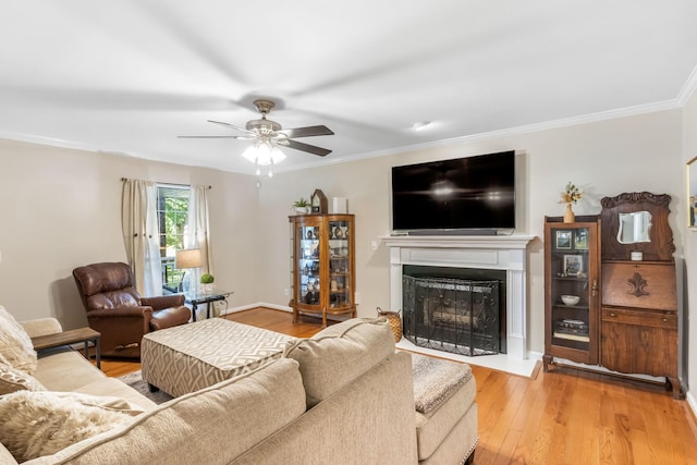 423 Adeline Dr, Smyrna, TN 37167 - living room featuring a fireplace with raised hearth, wood finished floors, ceiling fan, and ornamental molding
