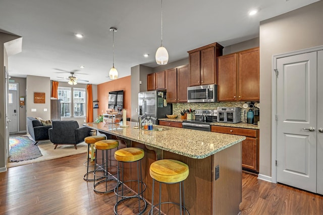 4316 Summercrest Blvd Unit 1020, Antioch, TN 37013 - kitchen with appliances with stainless steel finishes, open floor plan, decorative backsplash, a breakfast bar, and a ceiling fan
