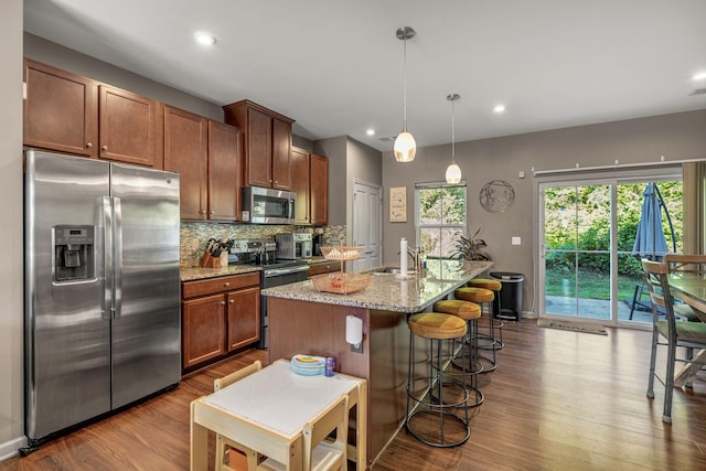 4316 Summercrest Blvd Unit 1020, Antioch, TN 37013 - kitchen with appliances with stainless steel finishes, dark wood-style flooring, tasteful backsplash, a center island with sink, and recessed lighting
