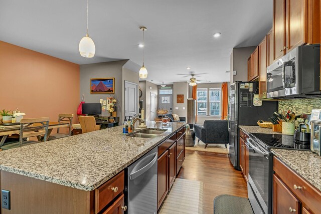 4316 Summercrest Blvd Unit 1020, Antioch, TN 37013 - kitchen featuring appliances with stainless steel finishes, open floor plan, dark wood-style floors, an island with sink, and decorative backsplash