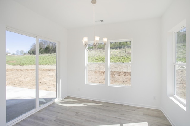 3044 Fernwood Ln, Columbia, TN 38401 - unfurnished dining area featuring light wood-style flooring, a chandelier, and plenty of natural light