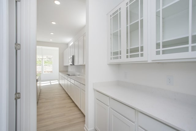 3044 Fernwood Ln, Columbia, TN 38401 - kitchen featuring white cabinetry, glass insert cabinets, light countertops, light wood-style floors, and recessed lighting