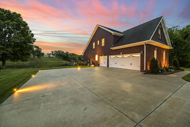 321 Lakeway Ter, Spring Hill, TN 37174 - property exterior at dusk featuring concrete driveway, brick siding, a lawn, a garage, and roof with shingles