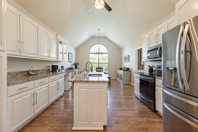 1057 The Long Run, Columbia, TN 38401 - kitchen with stainless steel appliances, lofted ceiling, a kitchen island with sink, and white cabinets