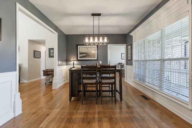 1057 The Long Run, Columbia, TN 38401 - dining room with vaulted ceiling, dark wood finished floors, wainscoting, a chandelier, and a decorative wall