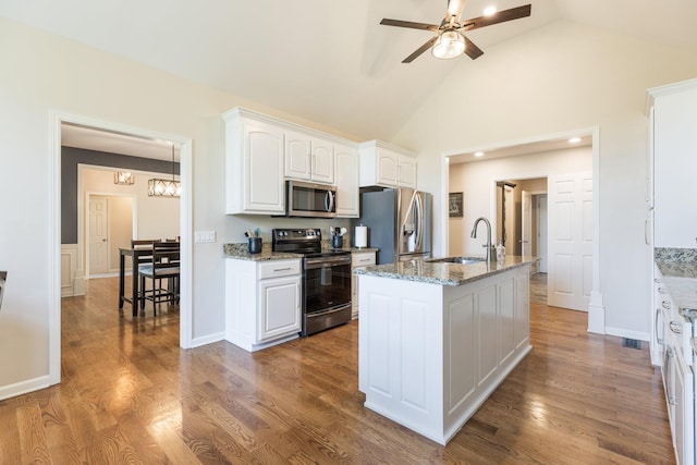 1057 The Long Run, Columbia, TN 38401 - kitchen featuring appliances with stainless steel finishes, a ceiling fan, white cabinets, light stone countertops, and a chandelier