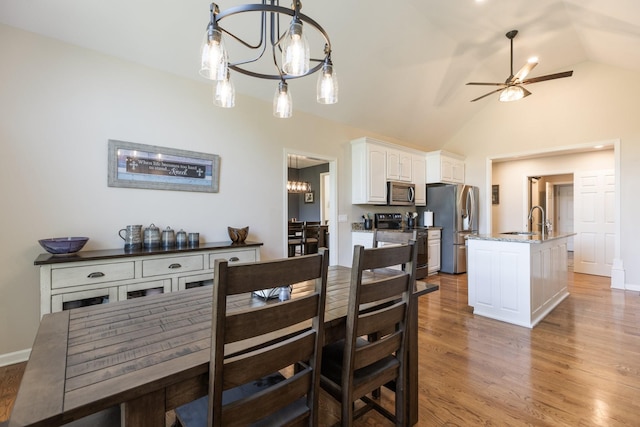 1057 The Long Run, Columbia, TN 38401 - dining room with a chandelier, vaulted ceiling, a ceiling fan, and light wood-type flooring
