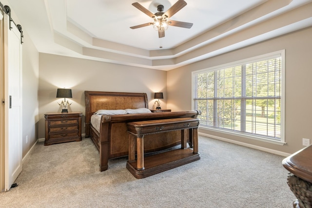 1057 The Long Run, Columbia, TN 38401 - bedroom featuring a barn door, light carpet, a raised ceiling, and a ceiling fan