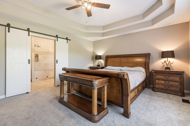 1057 The Long Run, Columbia, TN 38401 - bedroom with light carpet, a barn door, a raised ceiling, ensuite bathroom, and a ceiling fan