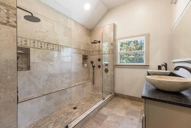 1057 The Long Run, Columbia, TN 38401 - full bathroom featuring double vanity, walk in shower, vaulted ceiling, and stone tile floors