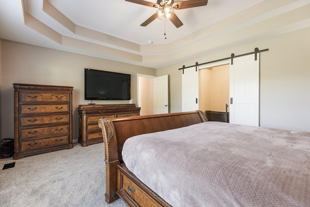 1057 The Long Run, Columbia, TN 38401 - carpeted bedroom with a barn door, a tray ceiling, and ceiling fan