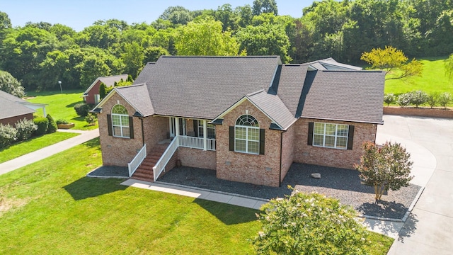 1057 The Long Run, Columbia, TN 38401 - ranch-style house featuring a front lawn, a shingled roof, covered porch, and brick siding