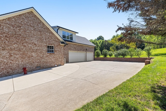 1057 The Long Run, Columbia, TN 38401 - view of property exterior featuring concrete driveway, an attached garage, brick siding, crawl space, and a lawn
