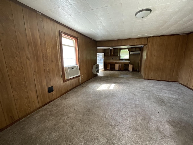180 Barbee Ave, Ripley, TN 38063 - unfurnished living room featuring plenty of natural light, wooden walls, carpet floors, heating unit, and cooling unit
