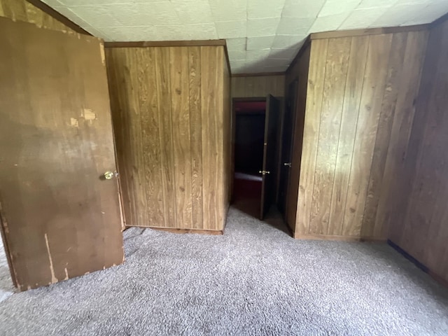 180 Barbee Ave, Ripley, TN 38063 - unfurnished bedroom featuring wooden walls and carpet flooring