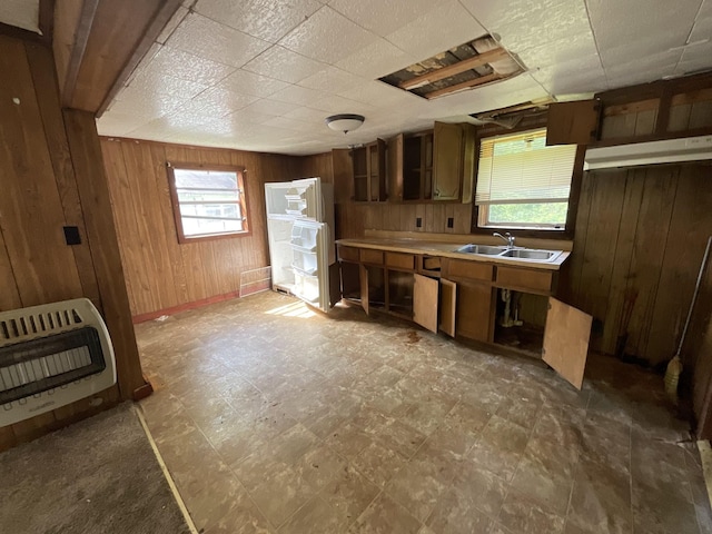 180 Barbee Ave, Ripley, TN 38063 - kitchen featuring heating unit, wooden walls, healthy amount of natural light, light countertops, and tile patterned floors