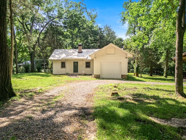 472 Shirley Rd, Smyrna, TN 37167 - view of front of house with a garage, dirt driveway, a chimney, a front yard, and a metal roof