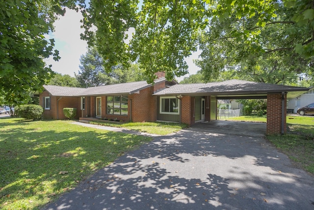 206 Ross Dr, Smyrna, TN 37167 - ranch-style home featuring asphalt driveway, a front lawn, a carport, a chimney, and brick siding