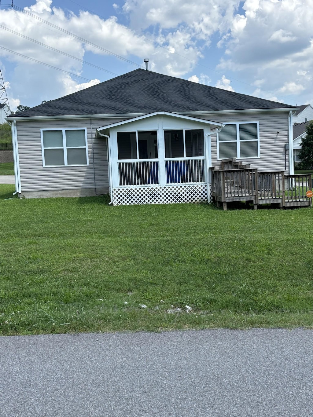 601 Sheyes Cir, Columbia, TN 38401 - view of front of property featuring a sunroom, a front yard, a deck, and roof with shingles