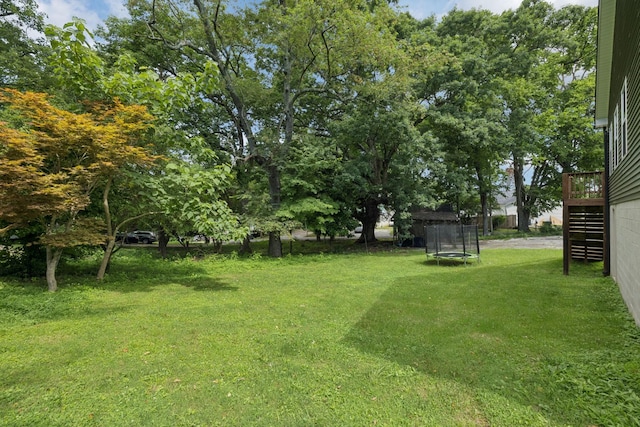 103 N Main St, Springfield, TN 37172 - view of grassy yard featuring a trampoline, stairway, and a deck