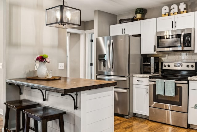 103 N Main St, Springfield, TN 37172 - kitchen with appliances with stainless steel finishes, white cabinets, and dark wood-style flooring