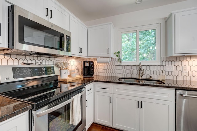 1448 Brighton Cir, Old Hickory, TN 37138 - kitchen with stainless steel appliances, white cabinetry, dark stone countertops, and tasteful backsplash