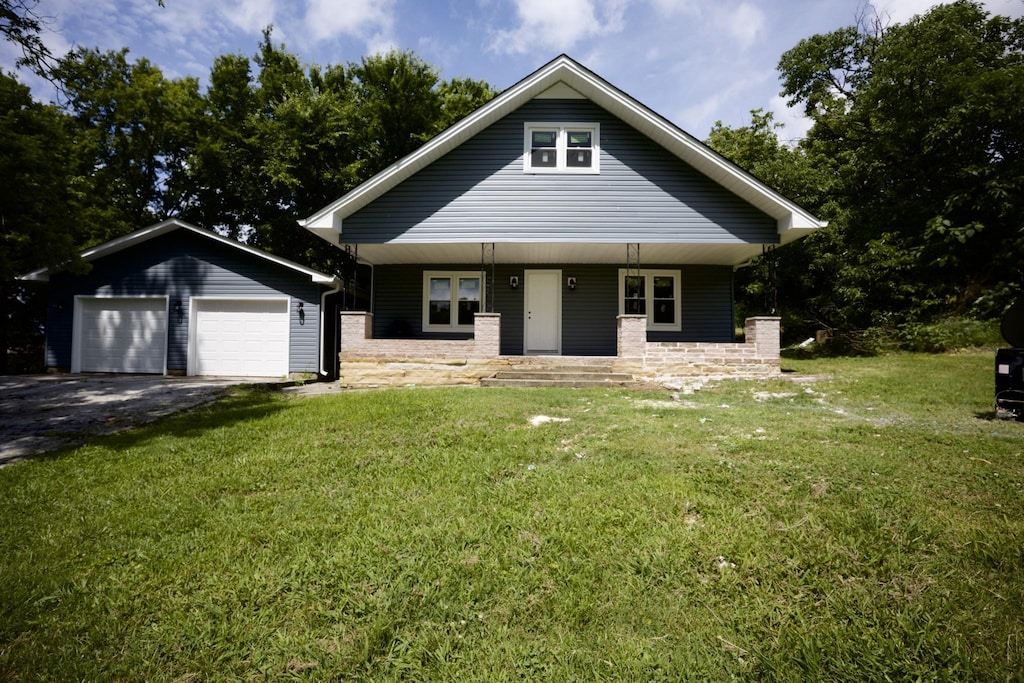 213 England St W, Cowan, TN 37318 - view of front of home featuring an outdoor structure, a porch, a front lawn, and driveway