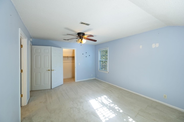 3171 Asbury Ln, Murfreesboro, TN 37129 - unfurnished bedroom featuring light carpet, a walk in closet, a closet, and ceiling fan
