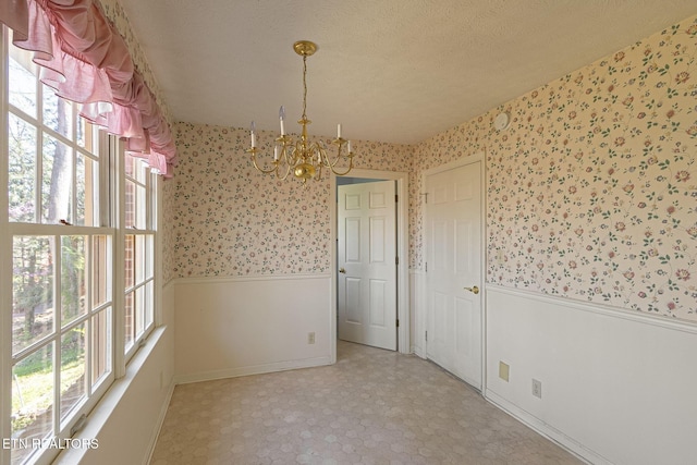 182 Whippoorwill Dr, Oak Ridge, TN 37830 - unfurnished dining area featuring wainscoting, wallpapered walls, a chandelier, a textured ceiling, and tile patterned floors