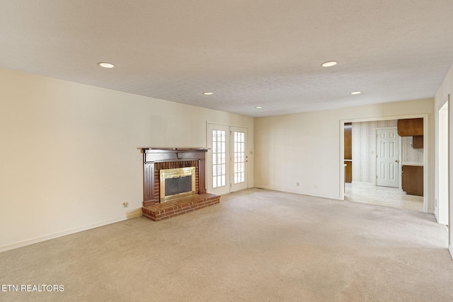 182 Whippoorwill Dr, Oak Ridge, TN 37830 - unfurnished living room with light colored carpet, a brick fireplace, recessed lighting, and a textured ceiling
