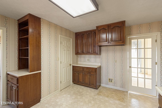 182 Whippoorwill Dr, Oak Ridge, TN 37830 - kitchen featuring wallpapered walls, open shelves, light countertops, and a textured ceiling