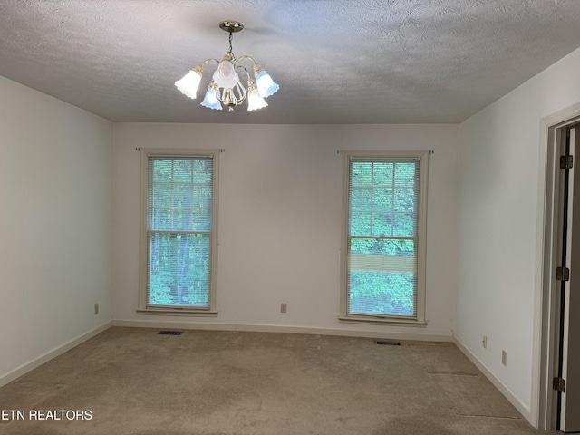 182 Whippoorwill Dr, Oak Ridge, TN 37830 - empty room with a chandelier, a textured ceiling, and carpet floors
