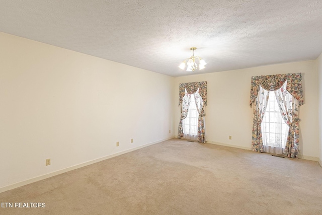 182 Whippoorwill Dr, Oak Ridge, TN 37830 - carpeted spare room featuring a chandelier and a textured ceiling