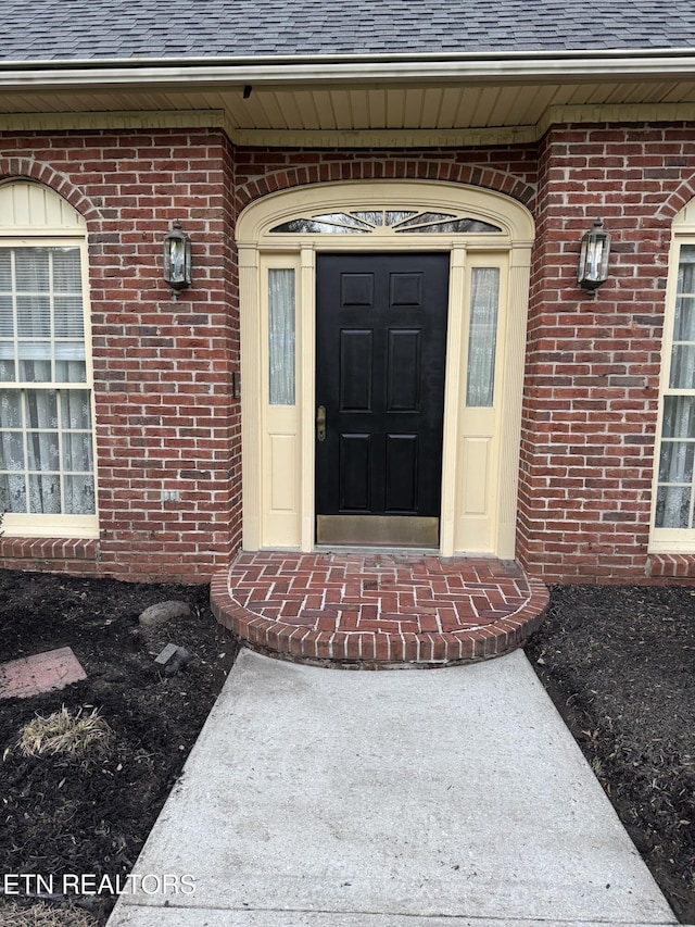 182 Whippoorwill Dr, Oak Ridge, TN 37830 - view of exterior entry featuring a shingled roof and brick siding