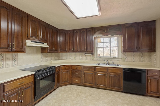 182 Whippoorwill Dr, Oak Ridge, TN 37830 - kitchen with black appliances, under cabinet range hood, light countertops, wallpapered walls, and light flooring