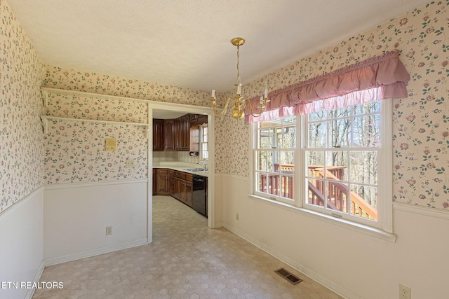 182 Whippoorwill Dr, Oak Ridge, TN 37830 - unfurnished dining area featuring wallpapered walls, a wainscoted wall, a chandelier, and light floors