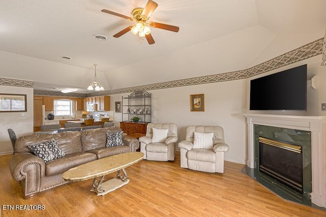 205 Ogle Dr Unit 554, Pigeon Forge, TN 37863 - living area with lofted ceiling, light wood-style floors, ceiling fan, and a fireplace