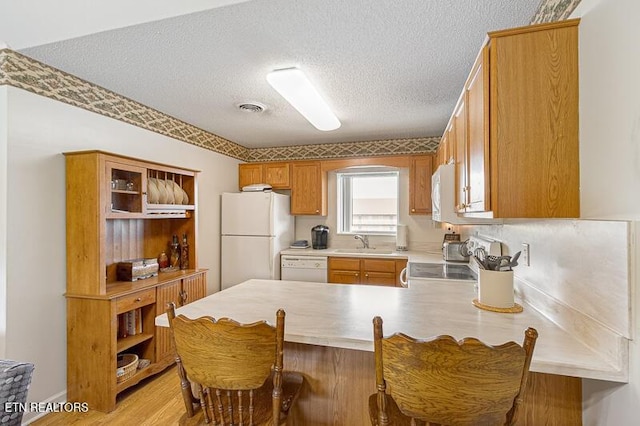 205 Ogle Dr Unit 554, Pigeon Forge, TN 37863 - kitchen with white appliances, open shelves, a peninsula, a textured ceiling, and light countertops