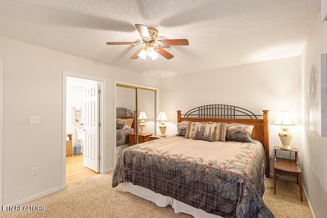 205 Ogle Dr Unit 554, Pigeon Forge, TN 37863 - bedroom featuring light colored carpet, a closet, a textured ceiling, ensuite bathroom, and a ceiling fan